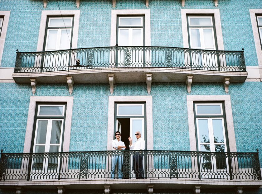 A building in Lisbon with two men on the balcony